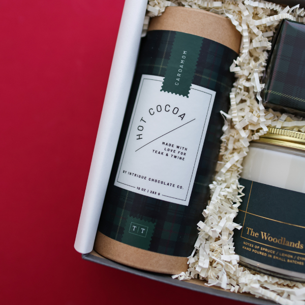 tube of hot cocoa with green plaid label in gift box