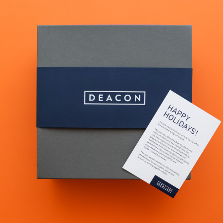 deacon branded packaging and note card on orange background