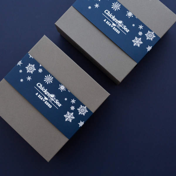 snowflake branded box sleeves on blue background