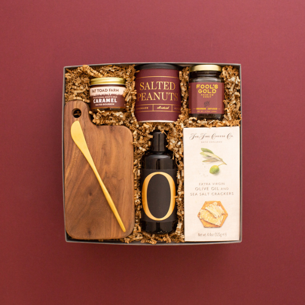 food themed holiday gift box on burgundy background
