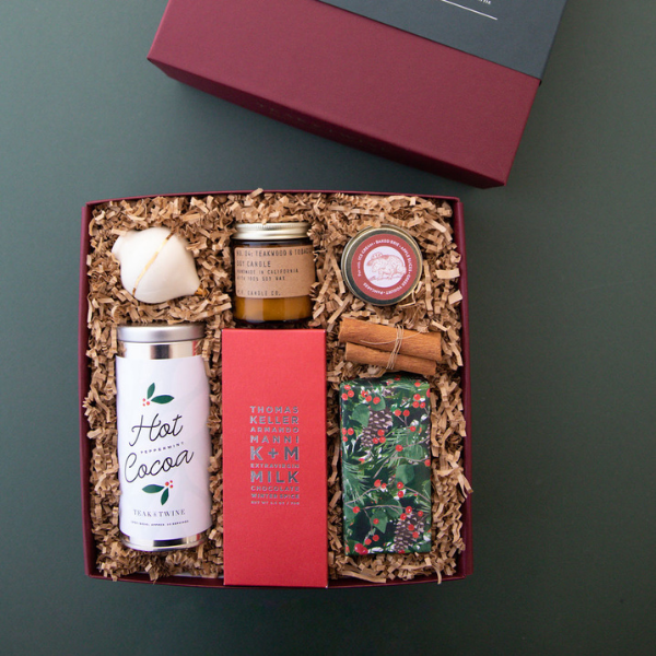red and green holiday gift box with snacks