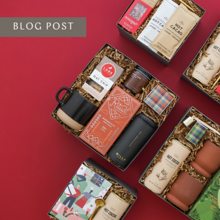 five colorful corporate holiday gifts in a flatlay on red background